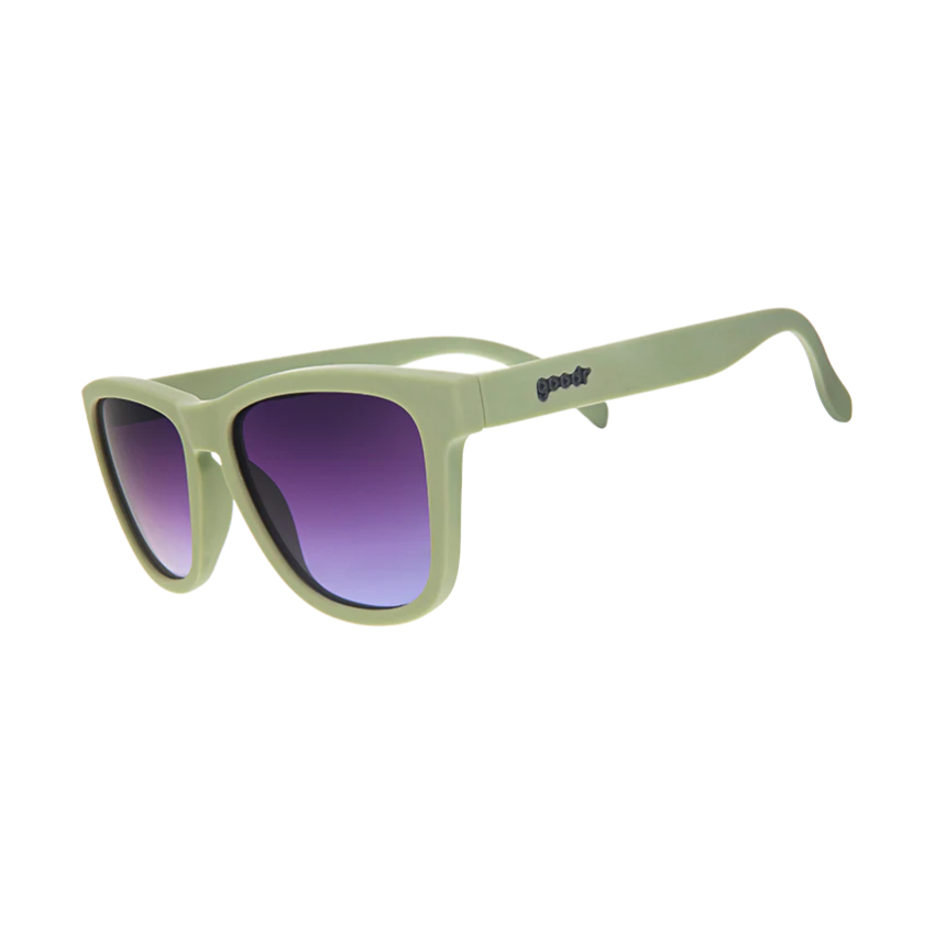 Photograph of goodr sunglasses featuring matte sage green frames goodr logo on the temple and striking purple to blue gradient lenses