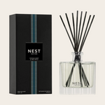 NEST New York product photograph of an Ocean Mist & Sea Salt Reed Diffuser, featuring a black box with a vertical blue and white striped band and a clear square glass bottle with black reeds