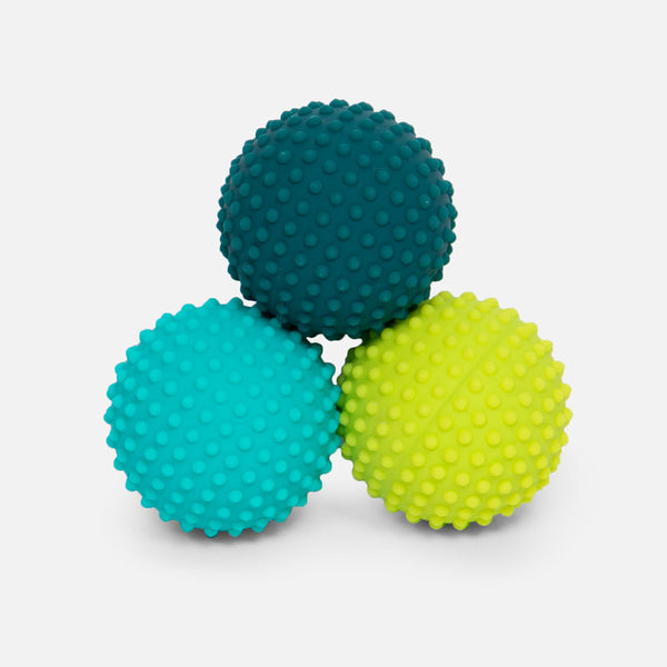 Three textured sensory balls in dark blue teal and lime green