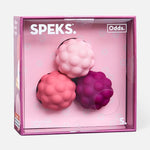 Three textured silicone spheres in pink and purple shades inside a square retail box