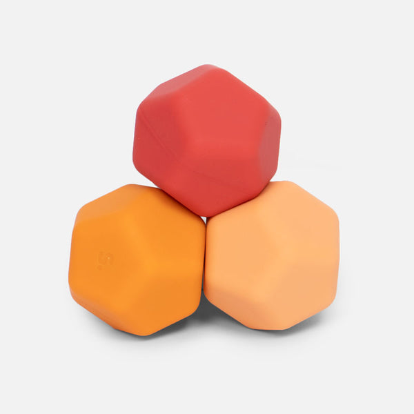 Three stacked hexagonal silicone blocks in red orange and light orange