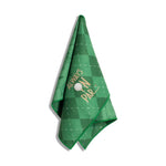 Green checkered golf towel hanging on a white background featuring embroidered gold text "ALWAYS ON PAR" with a white golf ball and tee graphic and a vibrant green trim