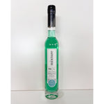 A tall slender glass bottle of Mixture bubble bath featuring vibrant aqua green liquid and a distinctive black wax-sealed top stands on a clean white surface with a minimalist white background showcasing its white label with "Mixture Bath Body" and "No 29 Opulence"