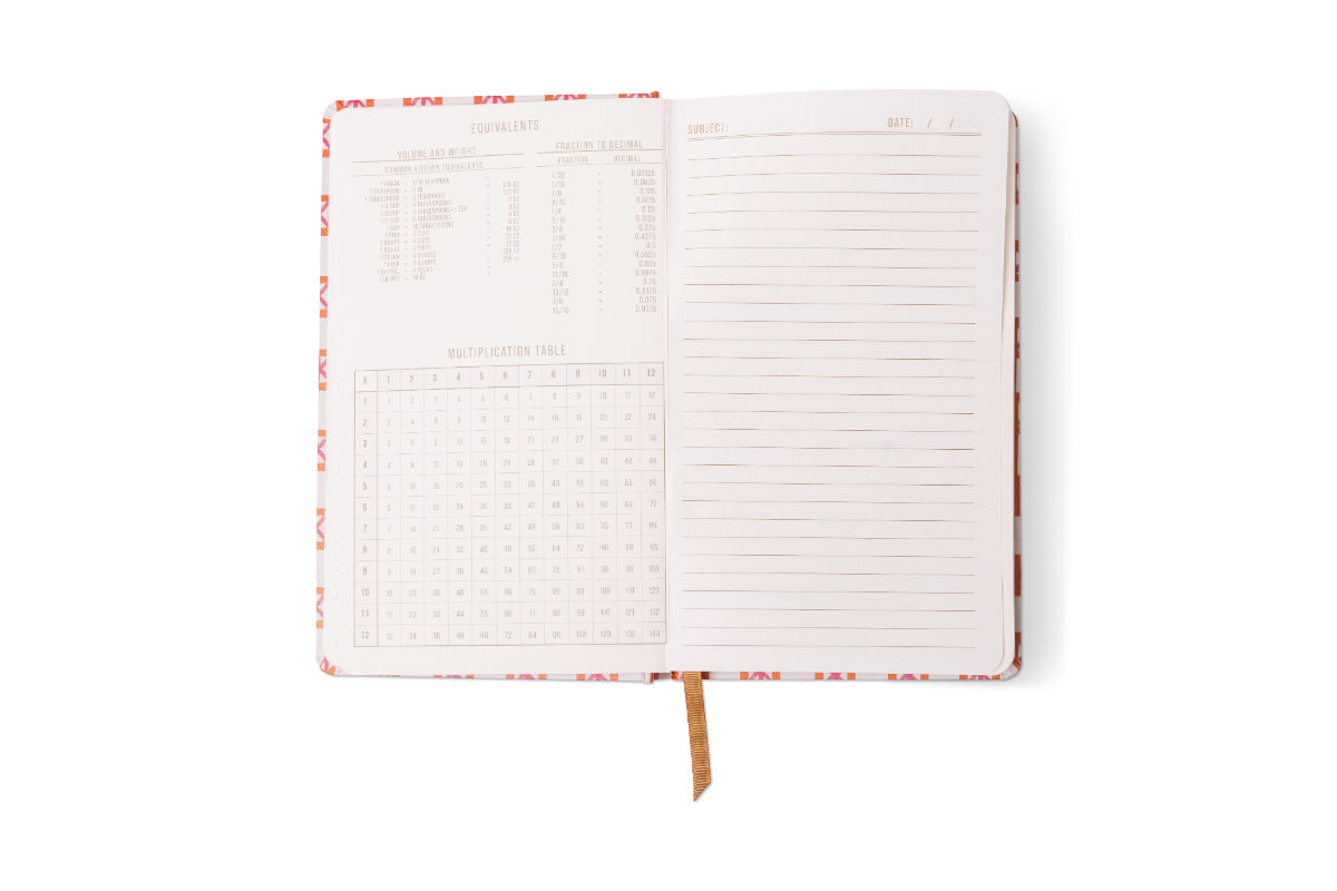 Open notebook on a white background with a colorful abstract patterned cover and gold ribbon bookmark, featuring a left page with kitchen equivalents and a multiplication table, and a right page with ruled lines and 'Subject Date' headers
