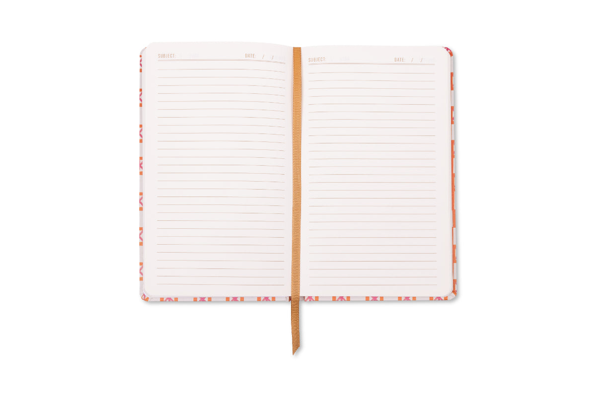 An open journal featuring lined pages with "SUBJECT" and "DATE" headers, a textured orange ribbon bookmark, and a vibrant pink and orange geometric pattern on its edges