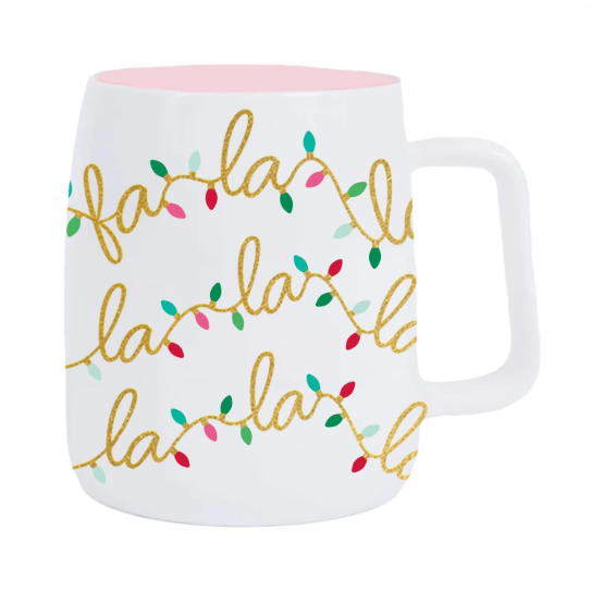Ceramic mug featuring a white exterior and light pink interior decorated with shimmering gold glitter 'fa la la' script text intertwined with festive red, green, and teal Christmas lights