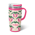 Swig insulated travel mug with a bright pink handle and clear lid accent featuring a cream body with a repeating tropical pattern of green palm trees pink spotted leopards and delicate pink flowers