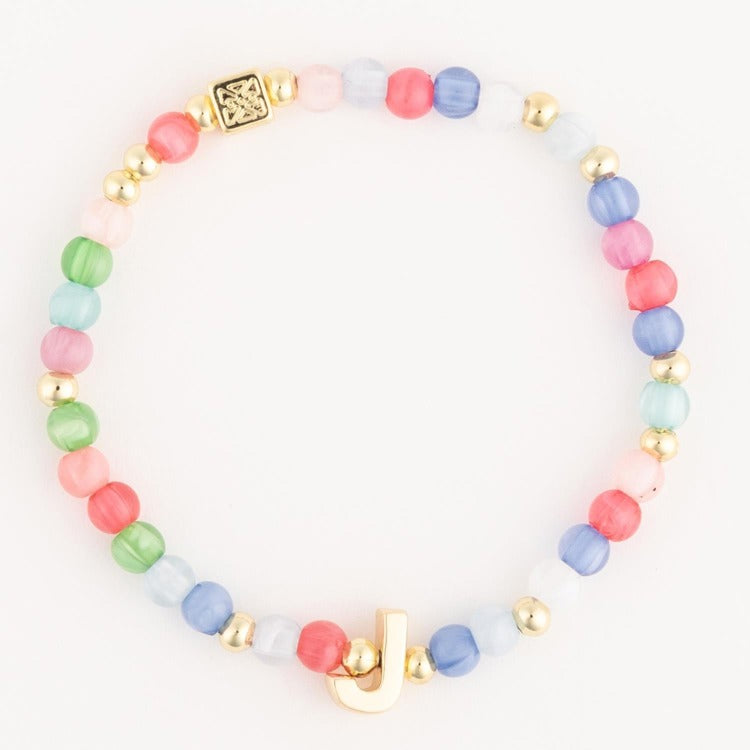 Beaded bracelet featuring multicolored pastel glass beads, gold spherical spacers, a prominent gold initial J charm, and a gold square designer clasp