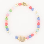 A colorful elastic bracelet featuring pastel round beads in various shades, a prominent gold initial M charm, and gold accent beads including a detailed square bead