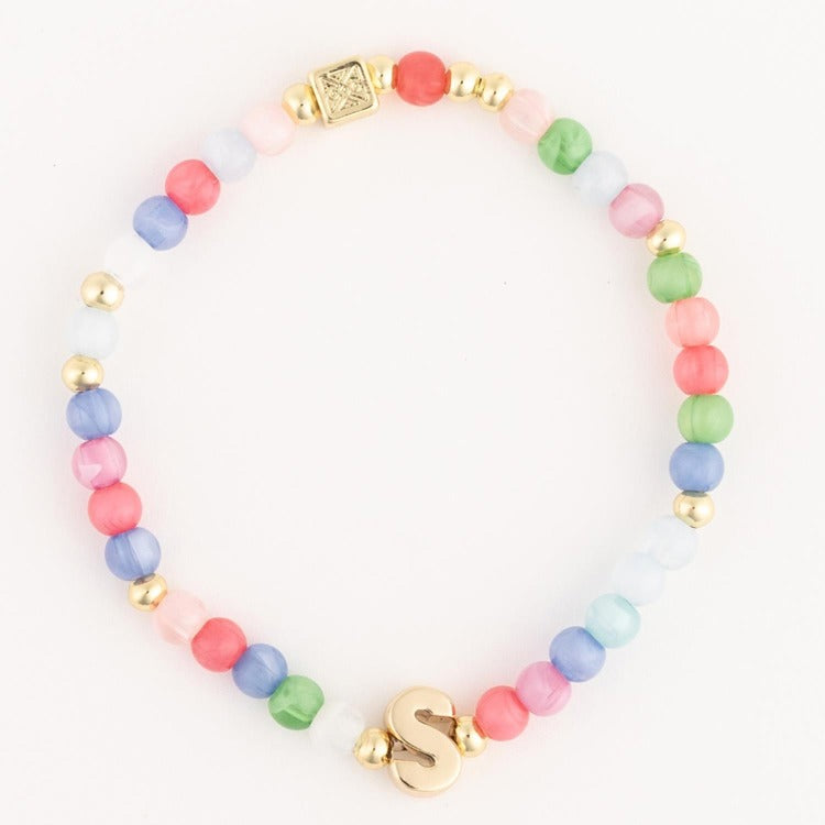 Jewelry a multicolor pastel beaded bracelet featuring gold accent beads a prominent gold initial S charm and a small embossed square gold bead