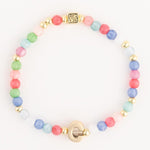 Beaded bracelet featuring a vibrant array of pastel-colored glass beads alternating with gold-toned spacers, a square patterned gold charm, and a distinctive G-shaped gold clasp
