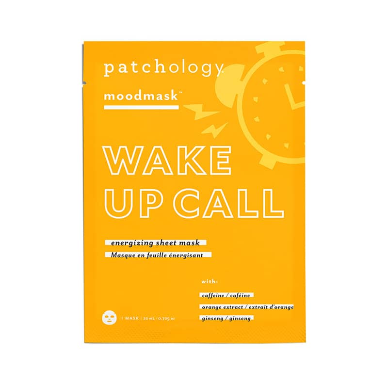 Graphic design packaging by Patchology for the Wake Up Call energizing sheet mask featuring a vibrant yellow background with a stylized white alarm clock illustration and bold typography highlighting caffeine and ginseng ingredients