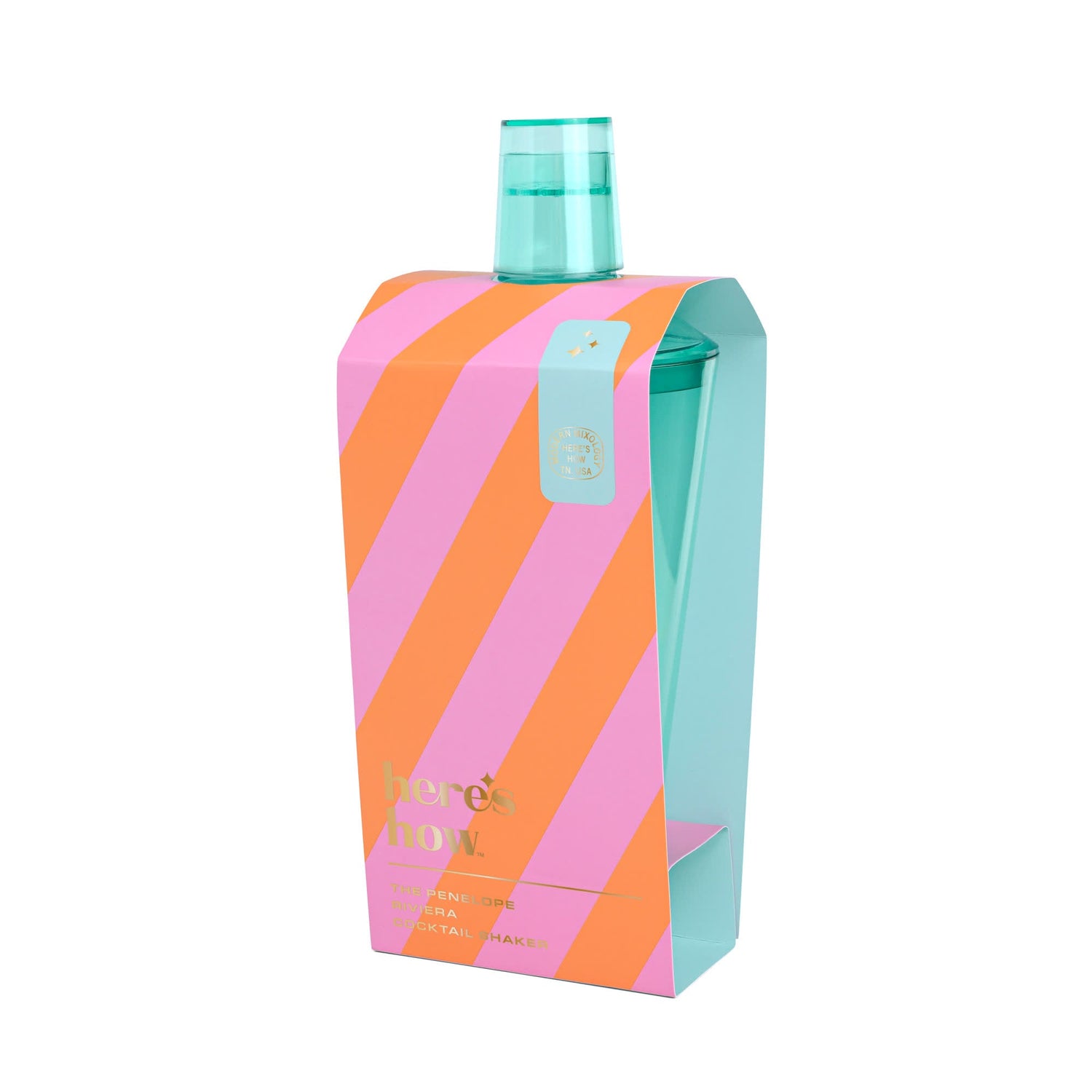 Product photography of a here's how Penelope Riviera cocktail shaker set, showcasing a teal blue shaker in packaging with bold pink and orange diagonal stripes and gold details including a small star emblem