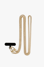 Gold-colored metal curb chain with two small lobster clasps attached to a black tab, presented against a clean white studio background