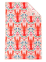 Crae patterned textile featuring a repeating design of bright orange lobsters interspersed with blue bell-shaped flowers red cherries and small pink bows