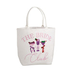 White canvas tote bag embroidered with pink text 'THE BRIDE Club' and three colorful sequined cocktail illustrations including a purple margarita, green martini, and red coupe adorned with bows