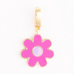 Jewelry charm of a flower with bright pink petals a light purple center and a gold-colored outline