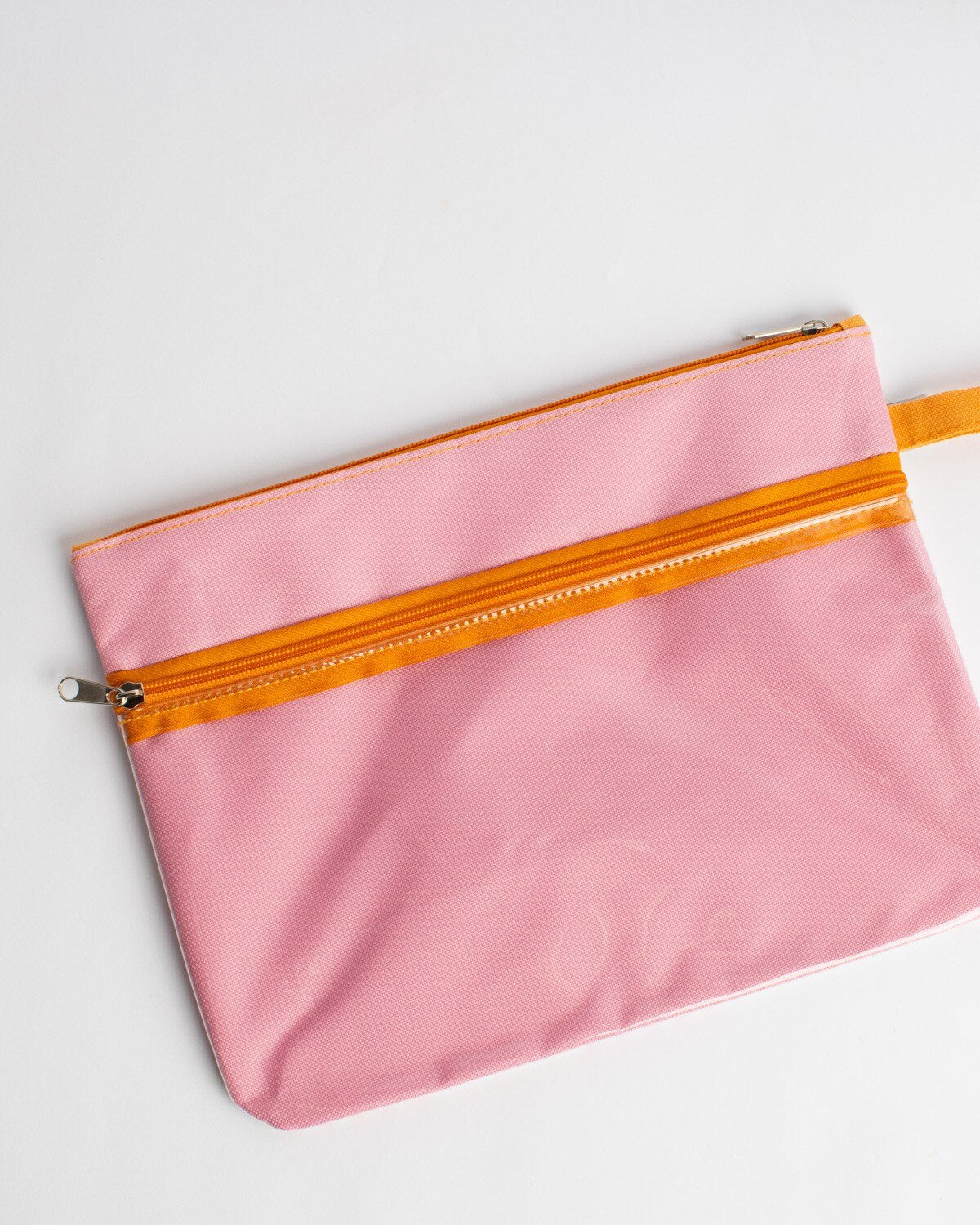 Pink fabric zipper pouch with orange zipper trim