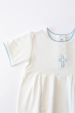 White baby Christening outfit featuring a light blue embroidered cross on the chest and matching light blue picot trim around the neckline and short sleeves