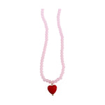 Rose quartz and ceramic beaded necklace featuring a glossy red heart-shaped pendant and translucent pink spherical beads displayed against a minimalist white background