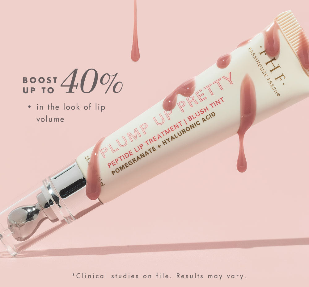 Farmhouse Fresh's Plump Up Pretty Peptide Lip Treatment Blush Tint tube is shown with pink drips and a rollerball applicator on a soft pink background, promising up to a 40% boost in lip volume with pomegranate and hyaluronic acid