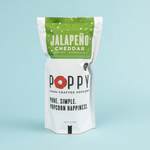 Poppy Hand-Crafted Jalapeño Cheddar popcorn in a white pouch featuring a green top band, a vibrant red poppy logo, and Made in Asheville NC text