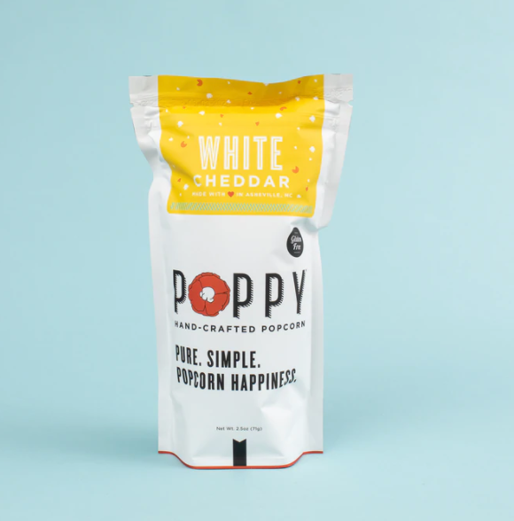 Product photo of a white and yellow stand-up pouch of Poppy Hand-Crafted White Cheddar Popcorn featuring a red poppy flower in the logo and a gluten-free badge on a light blue background