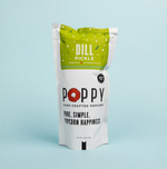 Poppy Hand-Crafted Dill Pickle popcorn in a white pouch with a lime green top section featuring a red poppy logo and "Made with love in Asheville NC" text against a light blue background