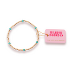 Beaded Blondes 14K gold filled beaded bracelet featuring bright turquoise accent beads and a prominent pink product tag