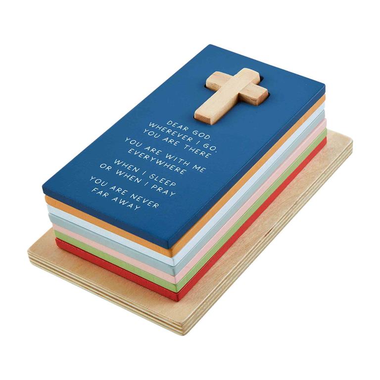 Stacked wooden blocks with a cross on top and printed religious text