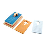 Stack of colorful wooden prayer cards with cross cutouts and printed text