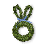 Boxwood wreath shaped like an Easter bunny with vibrant green leaves and a periwinkle blue ribbon isolated on a white background