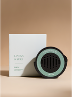 Black car fragrance diffuser with a mint ring beside its box