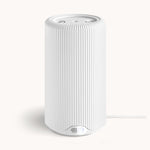 Modern white cylindrical home device featuring a vertical ribbed texture, a soft blue glowing power button at its base, and a white braided power cord, presented in a clean studio setting