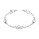 Silver beaded bracelet featuring five evenly spaced clusters of three polished spherical silver beads each with a larger central bead flanked by two smaller ones set on a continuous strand of numerous tiny silver beads