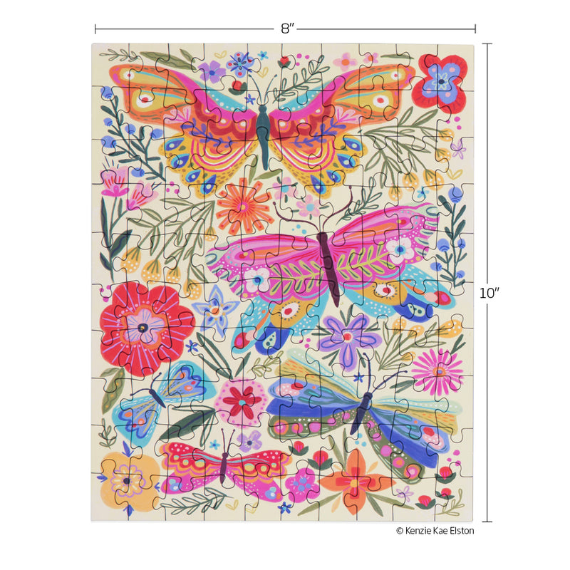 Jigsaw puzzle by Kenzie Kae Elston depicting a vibrant folk art garden scene filled with large ornate pink and orange butterflies, smaller blue and red butterflies, and a scattering of colorful stylized blossoms