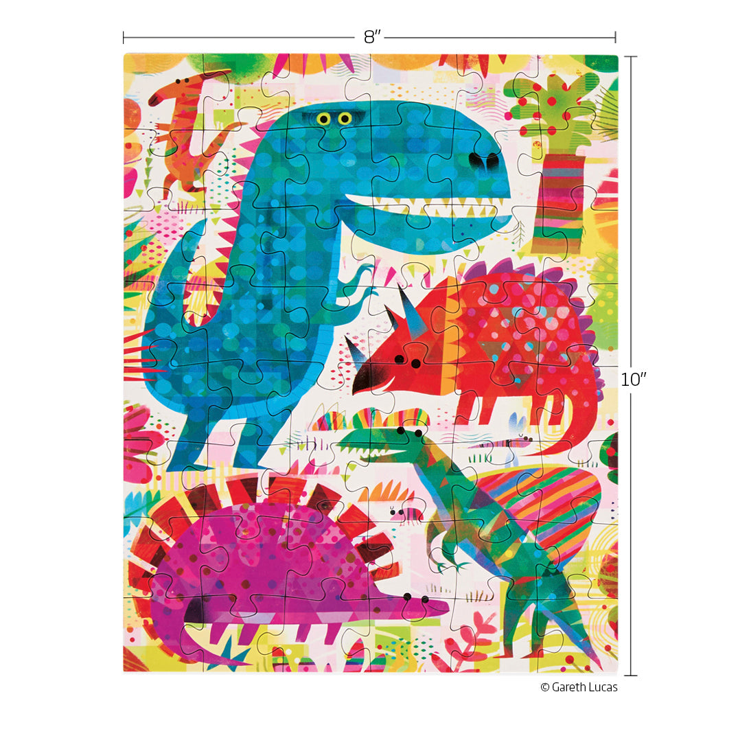 Puzzle by Gareth Lucas showcasing an 8x10 inch jigsaw with a large blue T-Rex, a red horned dinosaur, a green striped raptor, and a purple spiky dinosaur set against a vibrant abstract jungle background