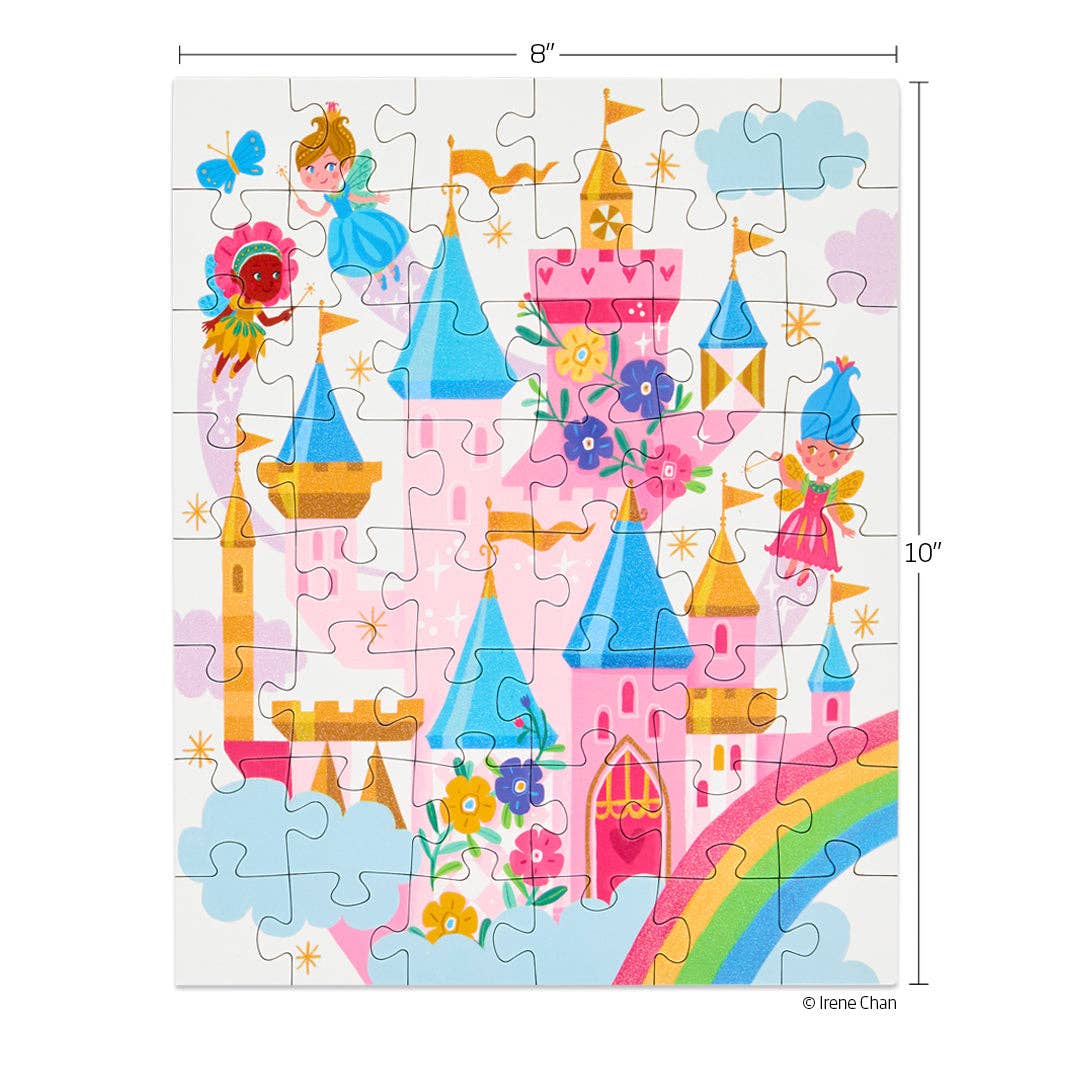 Jigsaw puzzle by Irene Chan depicting a whimsical pink castle with blue and gold turrets in a fairytale land, adorned with three colorful fairies, a vibrant rainbow, and golden stars