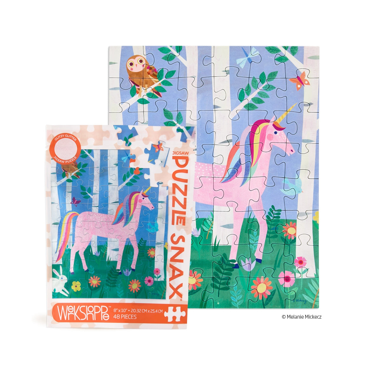 Jigsaw Puzzle by Melanie Mickecz depicts a pink unicorn with a rainbow mane and tail in a whimsical forest among white birch trees, colorful wildflowers, and a small owl