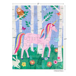 Children's puzzle by Melanie Mickecz featuring a pink unicorn with a rainbow mane and tail standing in a magical birch tree forest surrounded by a brown owl, white bunny, and colorful wildflowers
