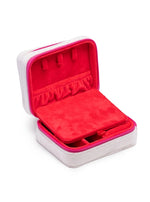 A white and fuchsia pink zippered jewelry box open to reveal a vibrant red velvet interior with earring holders and a removable divider on a white background