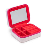 Open white travel jewelry case with red velvet interior and mirror
