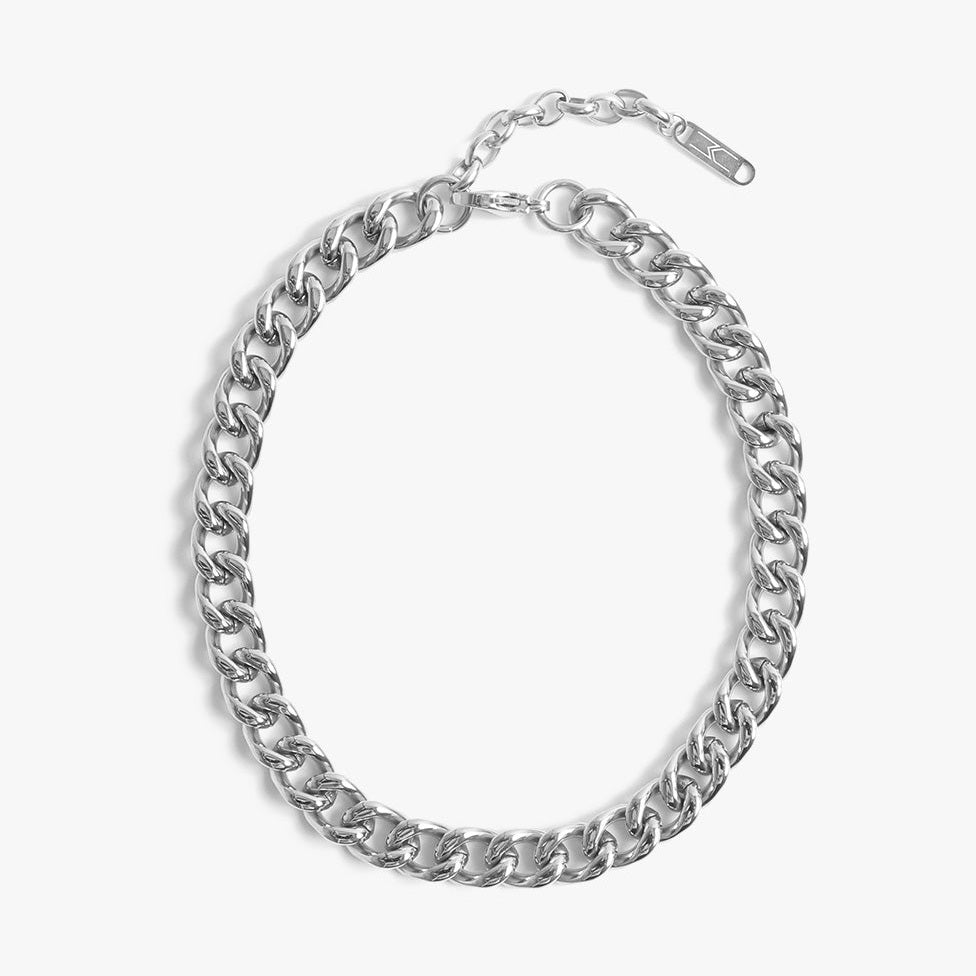 Silver chunky Cuban link chain necklace with a lobster clasp and small K-symbol tag on a white background