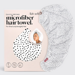 Kit•sch Quick-Drying Microfiber Hair Towel and its light pink packaging featuring a black and white dalmatian spot pattern, with a smiling woman modeling the towel on the box