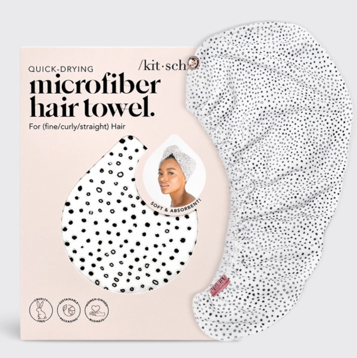 Kit•sch Quick-Drying Microfiber Hair Towel and its light pink packaging featuring a black and white dalmatian spot pattern, with a smiling woman modeling the towel on the box