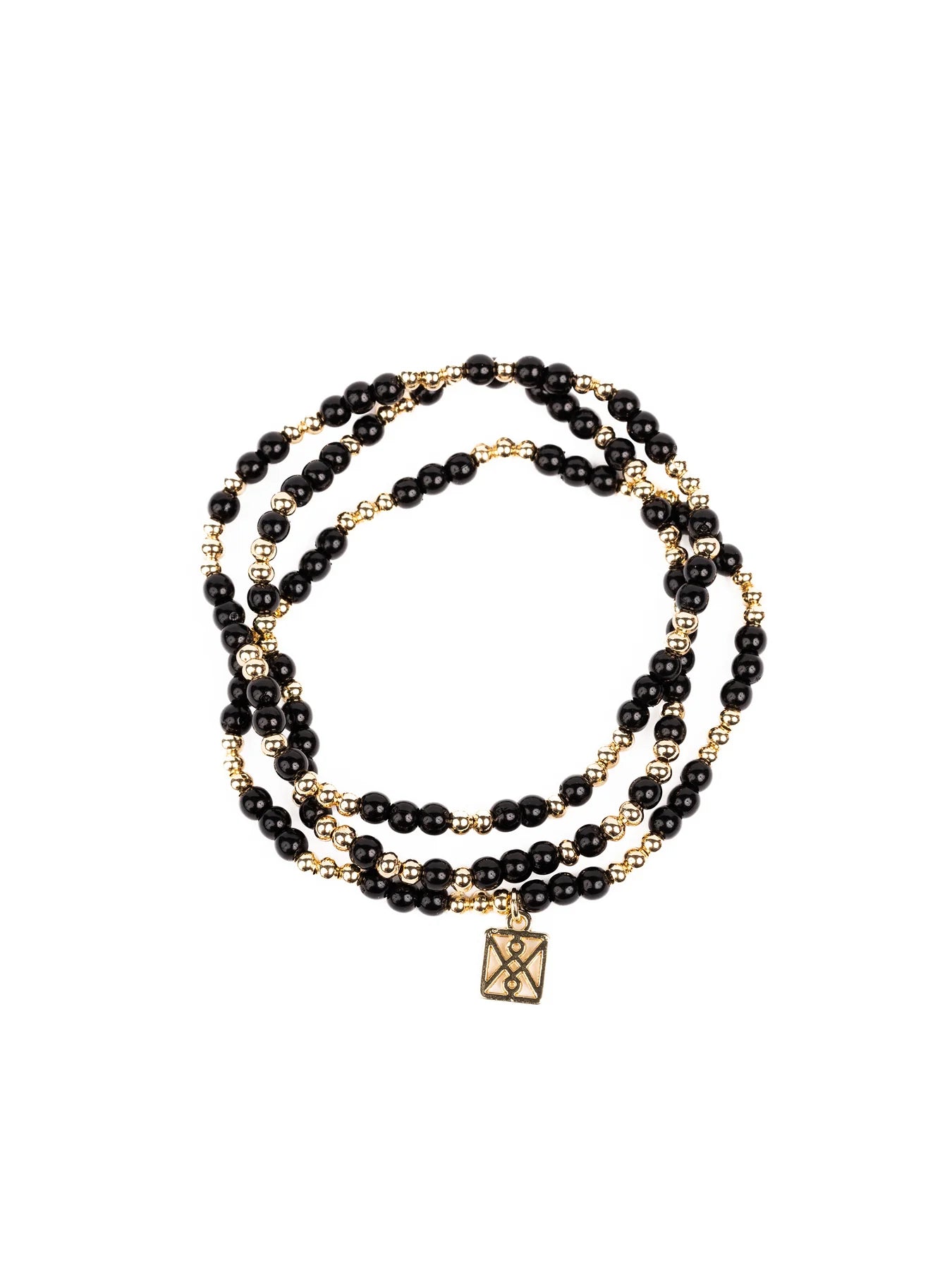 A multi-strand beaded wrap bracelet with alternating glossy black and small golden beads featuring a rectangular gold charm with an intricate geometric cut-out pattern