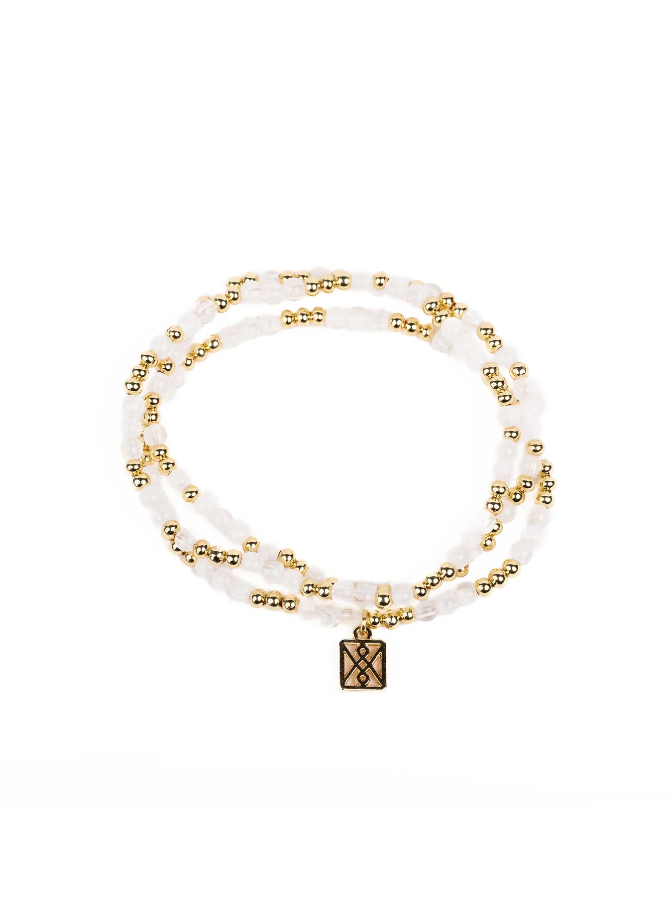 A multi-strand beaded bracelet featuring clear faceted beads, small gold spherical beads, and a square gold charm with an intricate geometric symbol