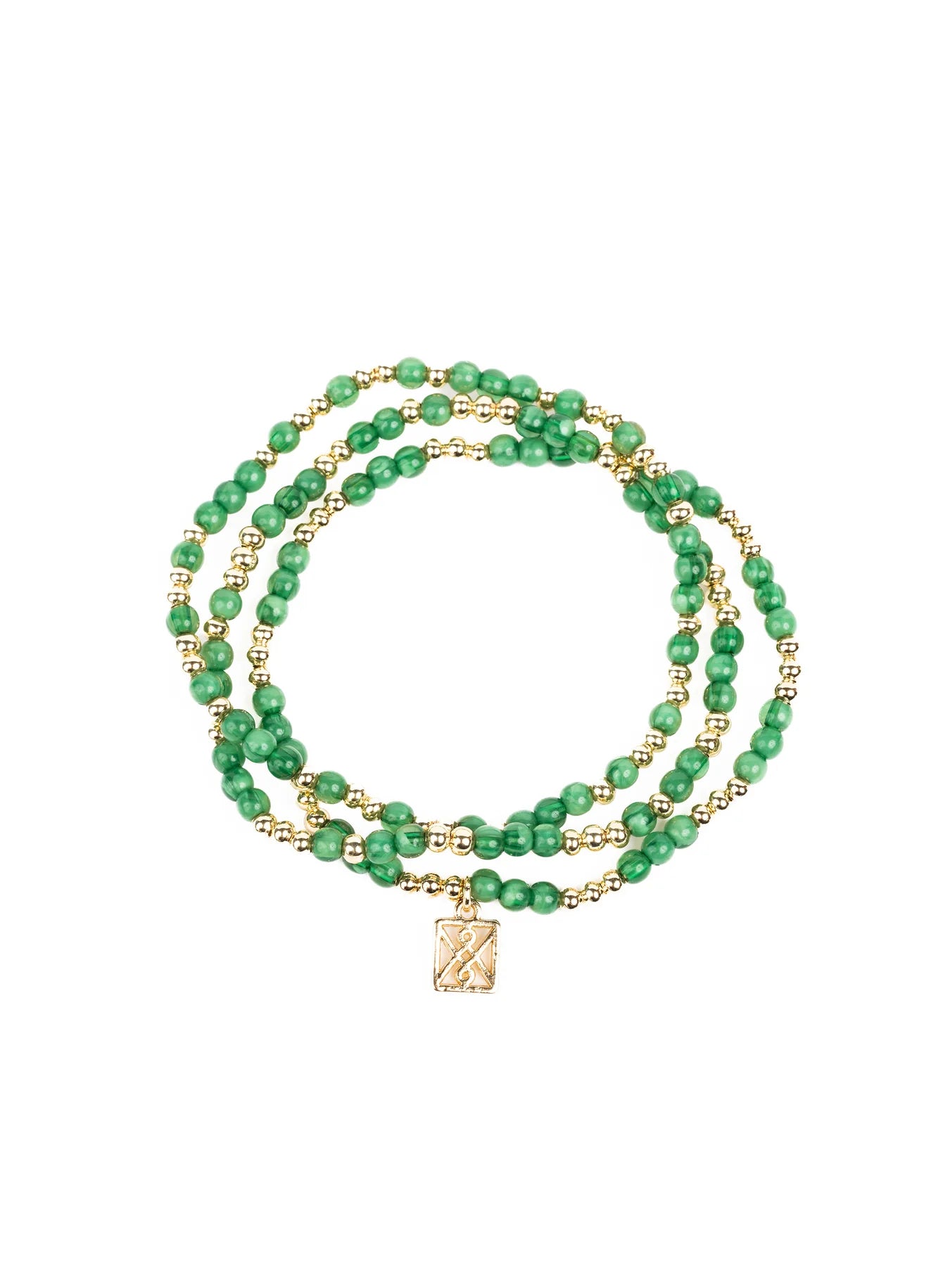 A three-strand beaded bracelet featuring alternating green malachite-like beads and small gold-tone spacer beads with a rectangular gold charm engraved with an X symbol