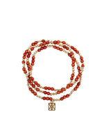 Triple-strand beaded bracelet crafted with polished reddish-brown carnelian-like stones and shiny gold accent beads featuring a square gold charm with an intricate geometric pattern