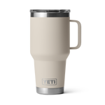 Product photography, a desert tan YETI Rambler travel mug featuring an integrated handle and clear MagSlider lid on a plain black background